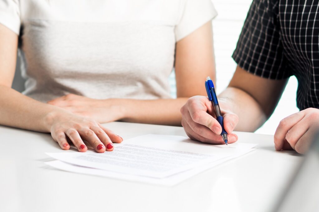 Divorce agreement. Couple signing legal document. Prenuptial agreement lawyer. Separation, breakup or lawsuit after family conflict. | Law Office of Eric Andrew Mercer Divorce agreement. Couple signing legal document. Prenuptial agreement lawyer. Separation, breakup or lawsuit after family conflict.