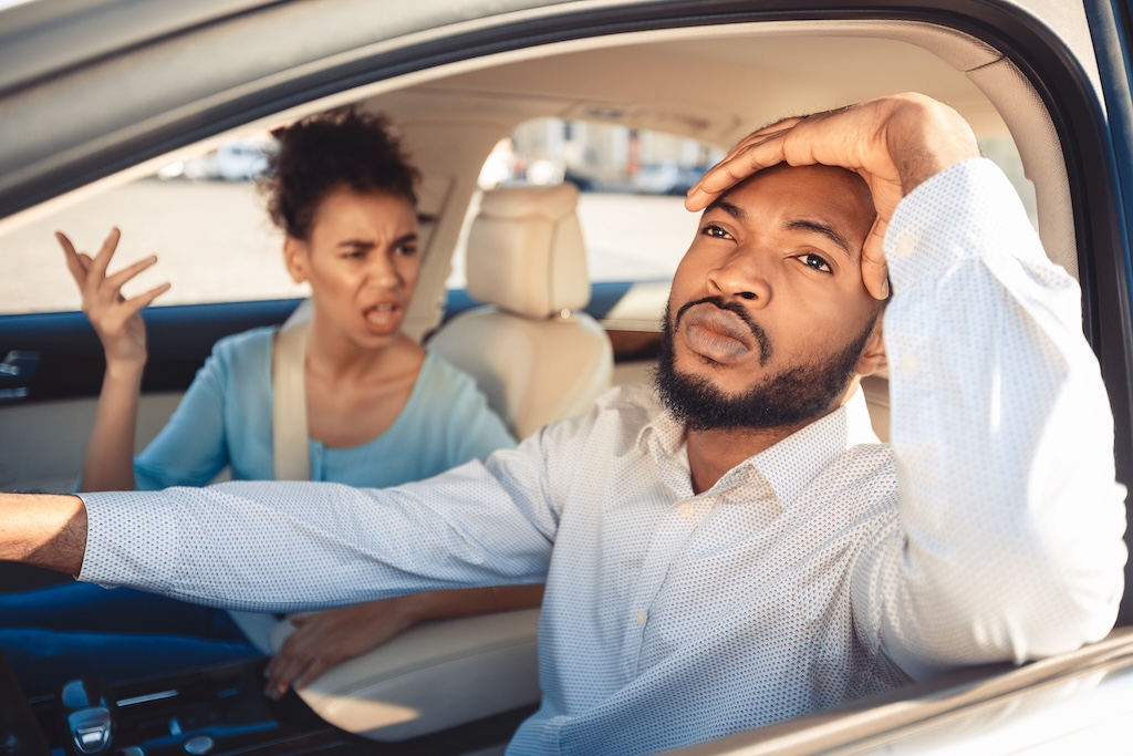 couple arguing during their journey in car, frustrated man looking aside couple arguing during their journey in car, frustrated man looking aside