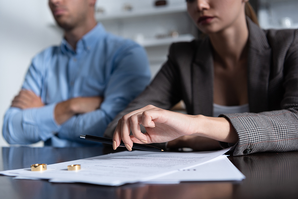 partial view of couple at table with divorce documents | Law Office of Eric Andrew Mercer California divorce lawyer, spousal support